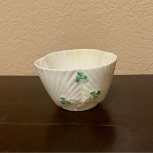 This is a Belleek Harp Shamrock pattern cockle shell shaped cereal bowl.